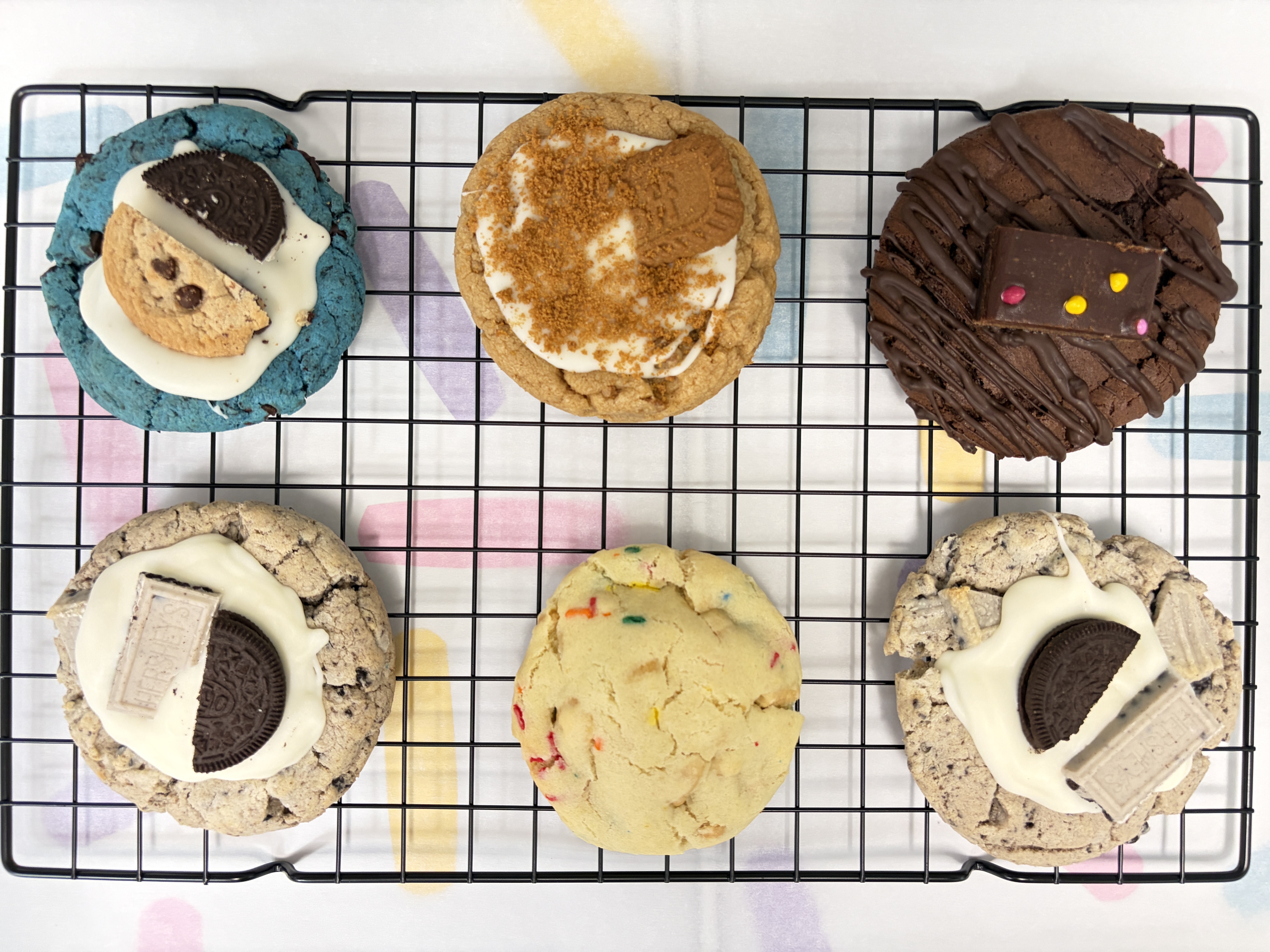 An assortment of handcrafted Sweet Beaver cookies displayed on a cooling rack